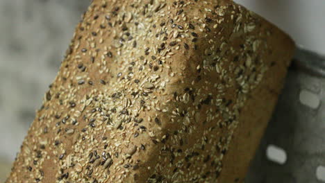 brown loaf of organic bread with multigrain seeds in the bakery