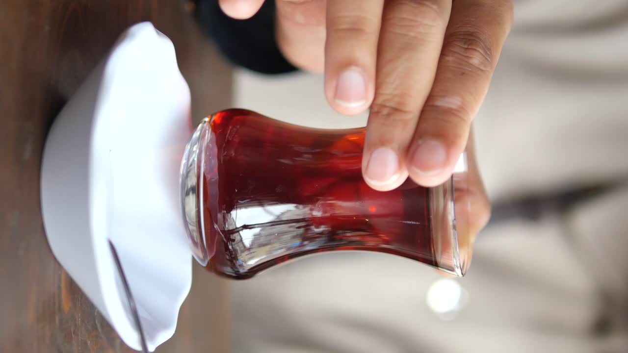 Person drinking Turkish tea