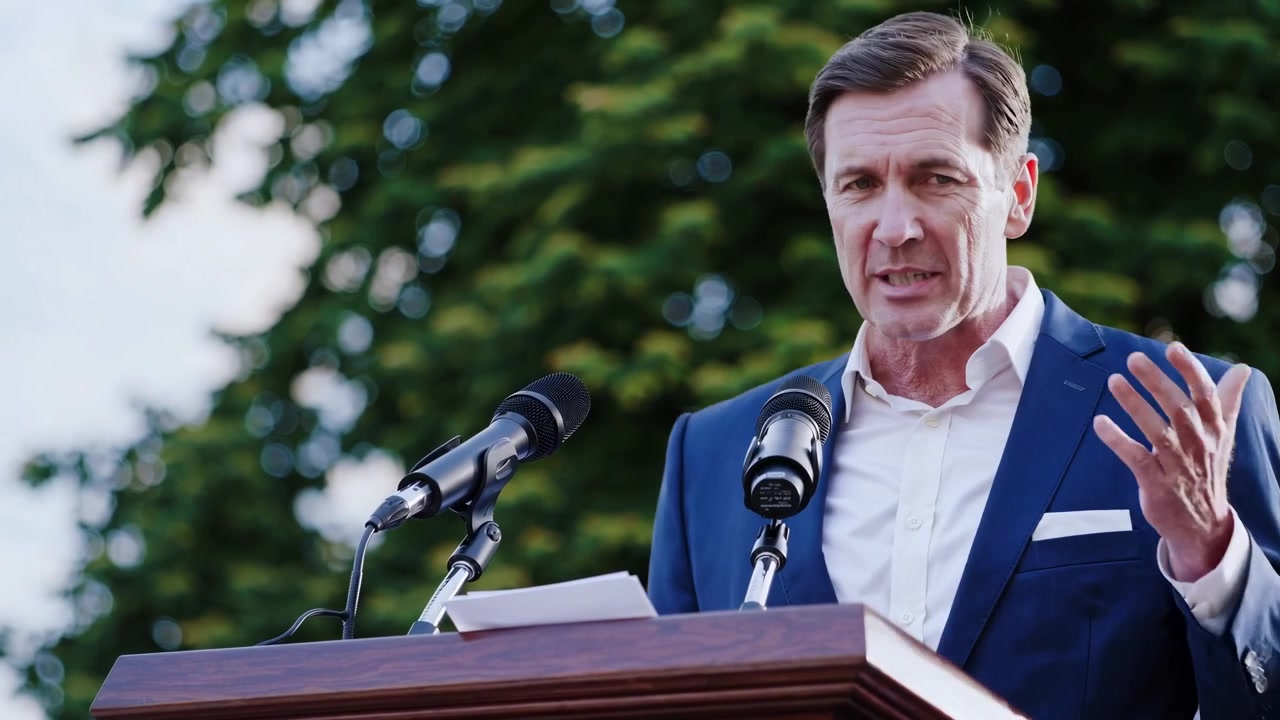 Professional Man Speaking at Podium with Microphones Outdoors