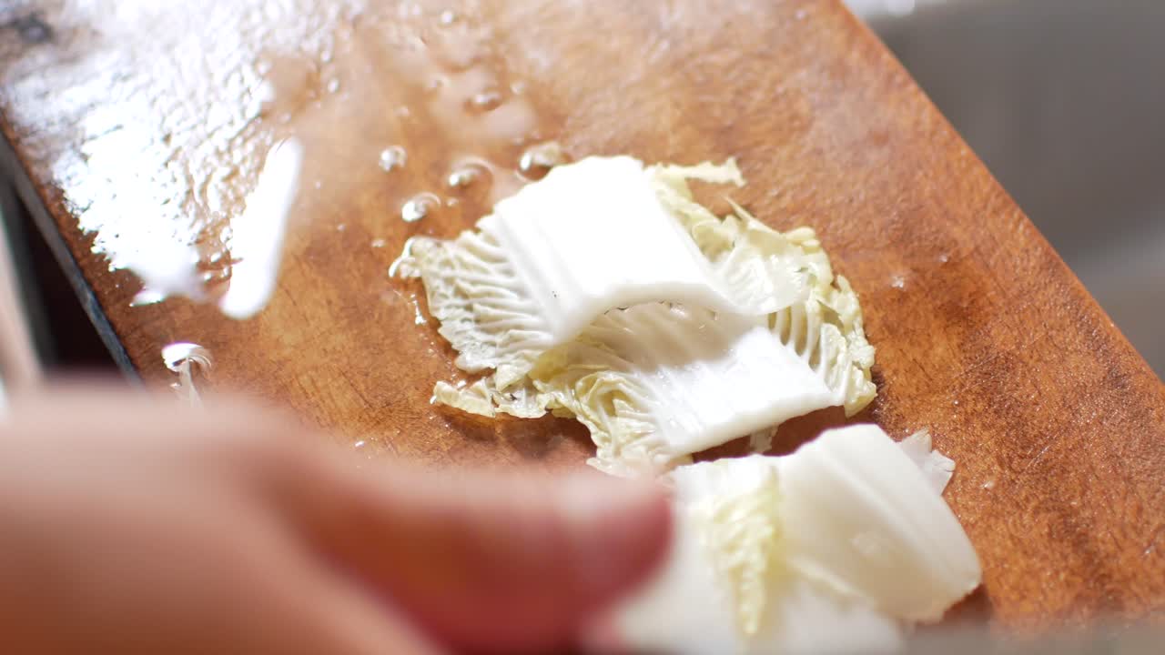 POV to the Nappa cabbage while being cut preparing for korean food cooking