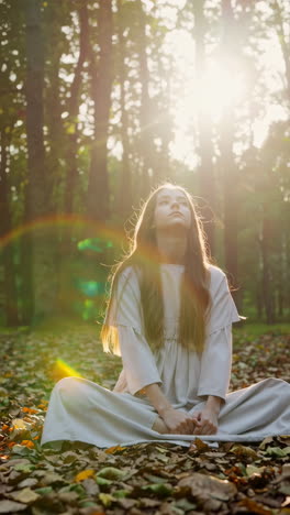 woman meditating peacefully in a sunlit forest