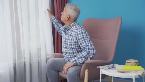 The man who opens the curtains yawns and relaxes.