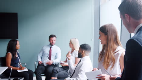 Group-Collaborating-On-Task-At-Graduate-Recruitment-Assessment-Day-Whilst-Being-Observed-By-Recruitment-Team