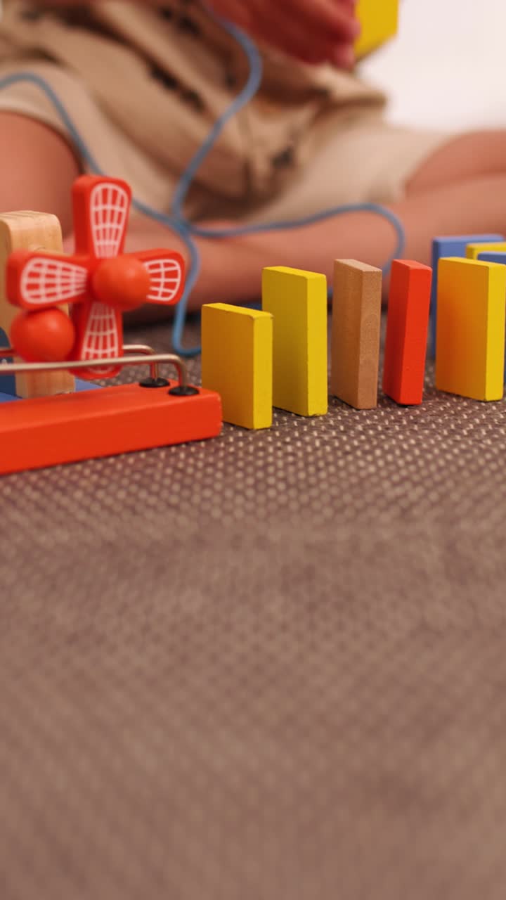 Child playing with educational toy on a carpet