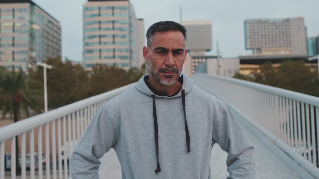 Portrait of a man in a hoodie in an urban setting
