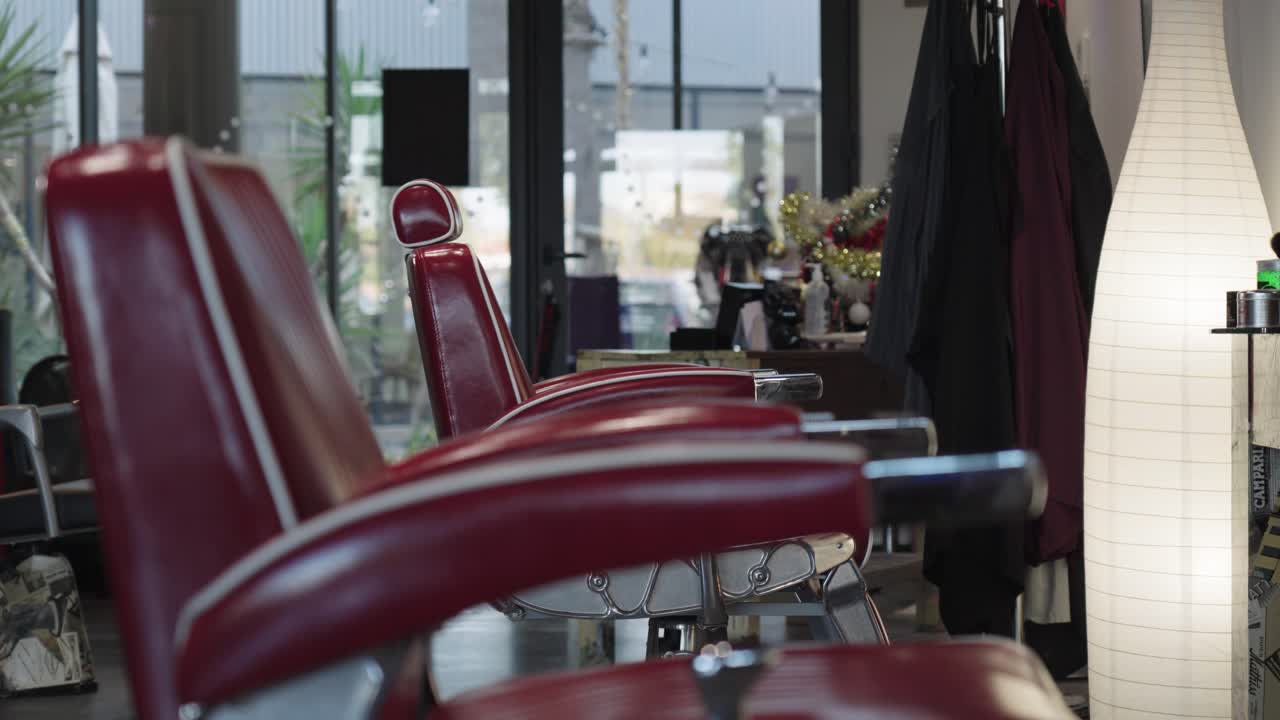 Old fashioned red barber shop chair and hairdresser