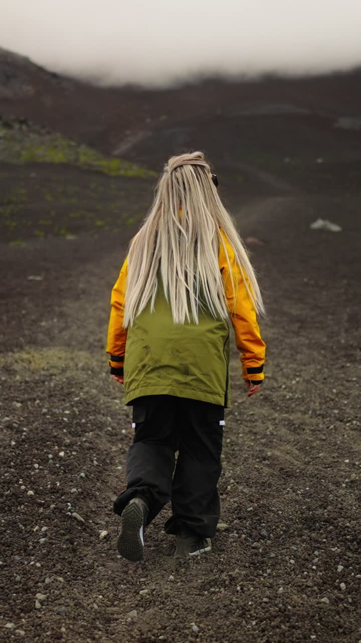Woman Walking on Rocky Mountain Path in Cloudy Weather
