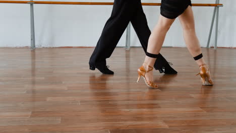 close-up of dancers' legs and feet in a dance studio