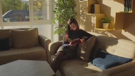 woman reading a book in a cozy cafe