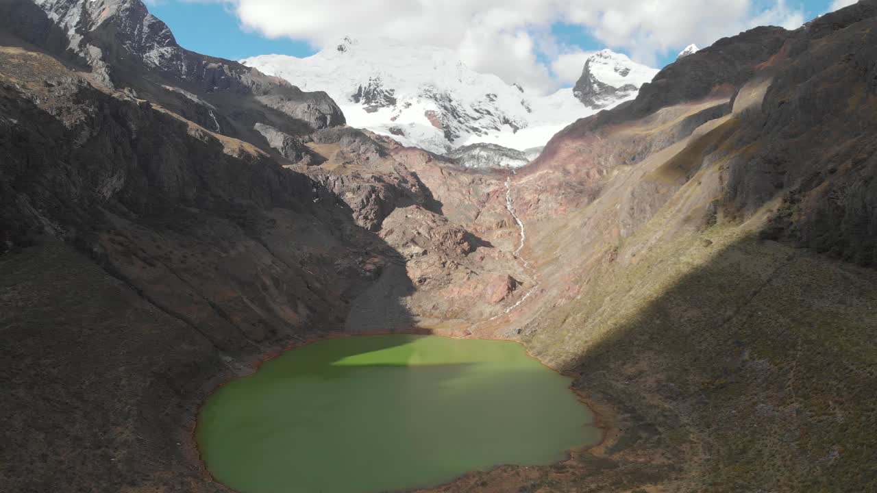 Green lake shallap, inmersive frontal flying, lake product of the defrosting glaciers, peruvian andes.