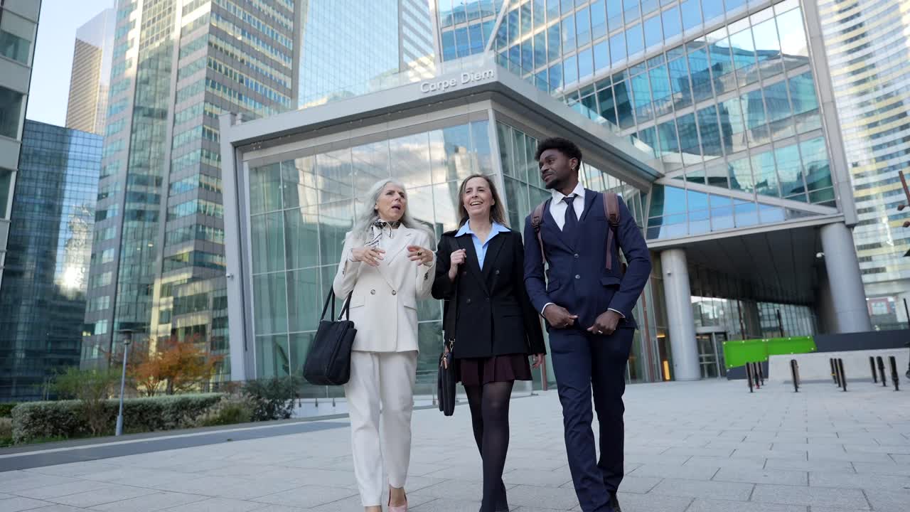 Business people walking in front of an office building