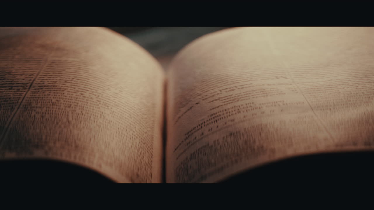 An someone turn pages of an old book inside the sailing ship cabin