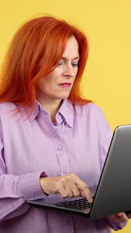 woman gets frustrated while using a laptop