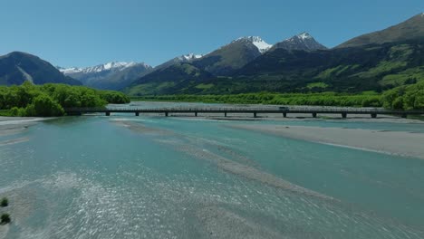 Stunning-turquoise-Rees-River-flowing-through-green-valley-in-New-Zealand