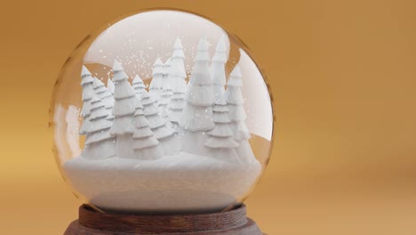 enchanted winter forest within a snow globe on yellow background