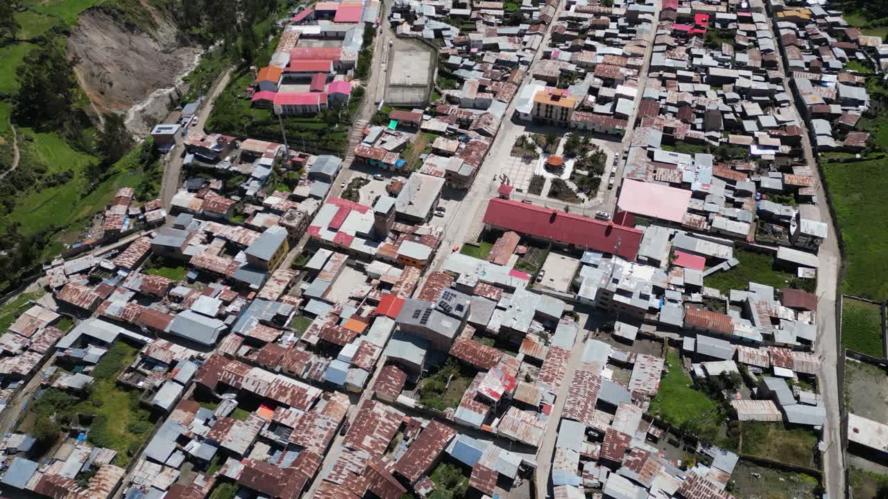 Aerial tilts over beautiful mtn river valley town of Cajatambo, Peru