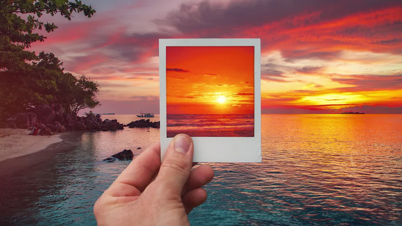 Tropical island beach sunset time lapse inside polaroid frame, held by hand, cinemagraph video loop