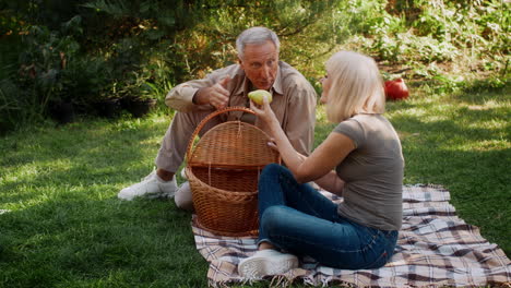 senior couple enjoying a picnic in the garden