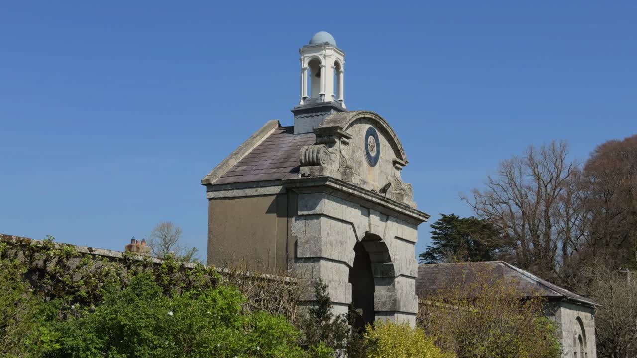 Ireland great Houses elaborate gatehouse and ornate gate to courtyard in summer