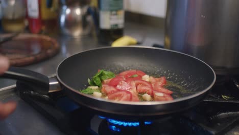 frying the tomatoes in the kitchen