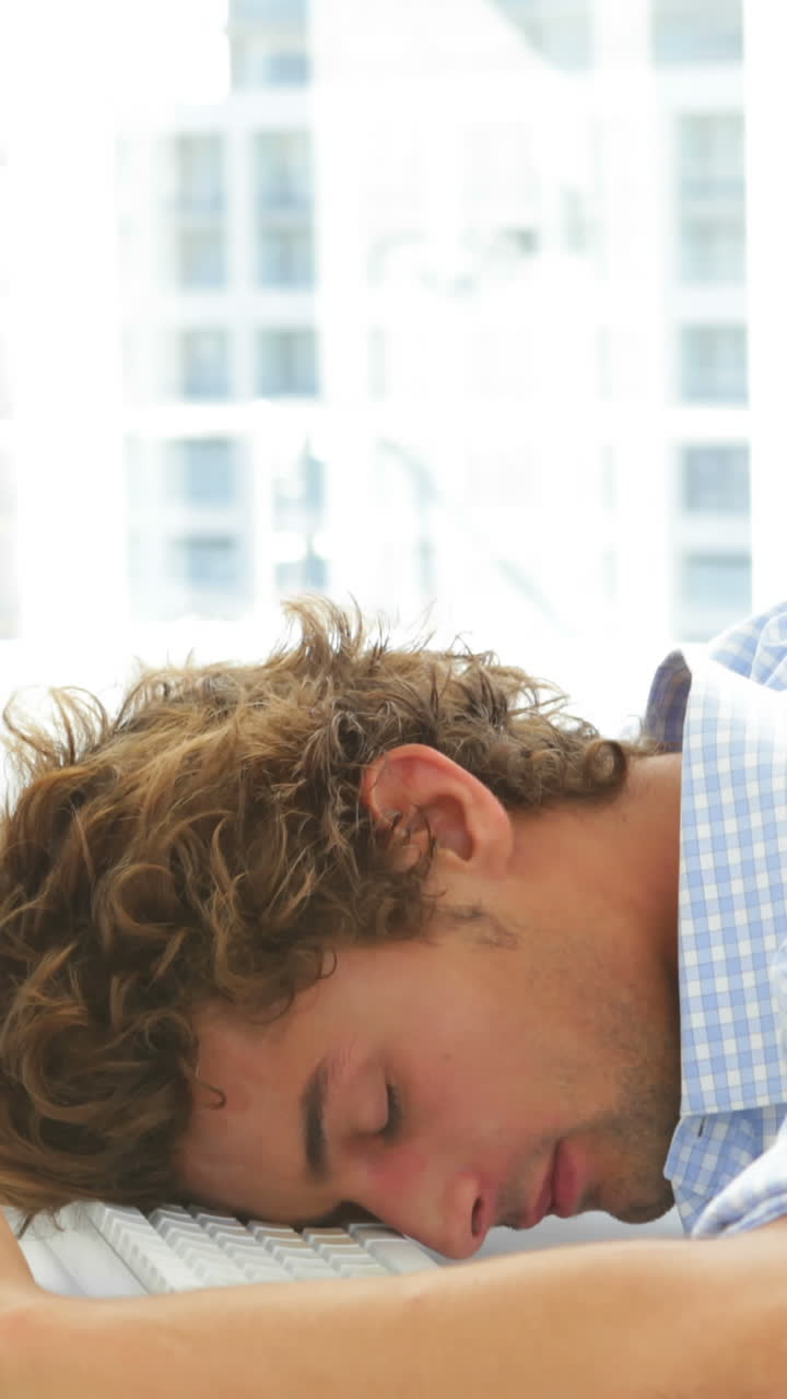 Attractive businesswoman waking up and falling asleep again