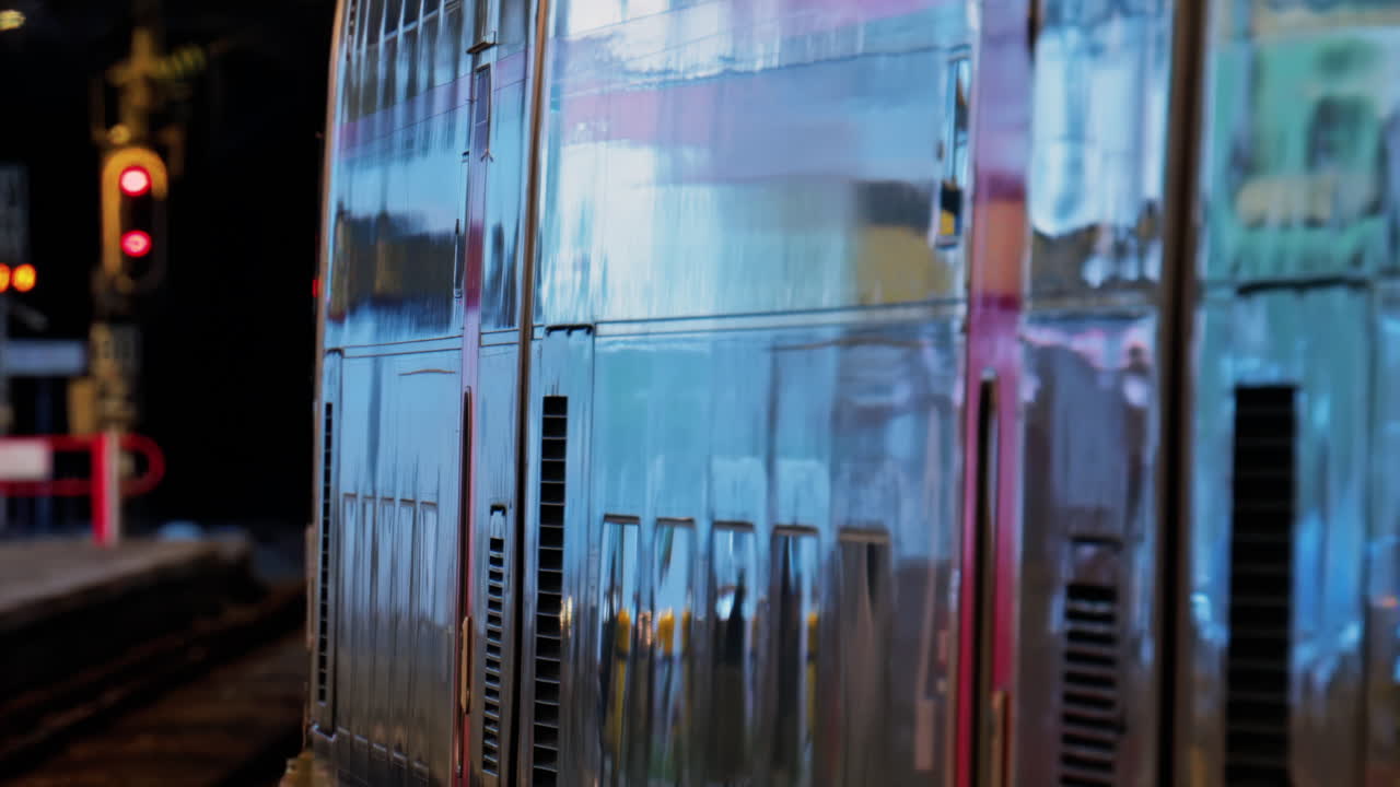 Close up of a train moving on the rails near a station in the south of France at night