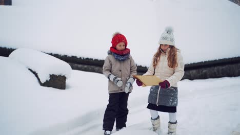 happy boy and girl in winter park. happy children playing on a winter walk in nature