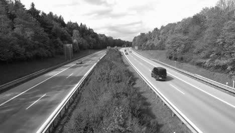 driving cars at a autobahn in black and white without colors