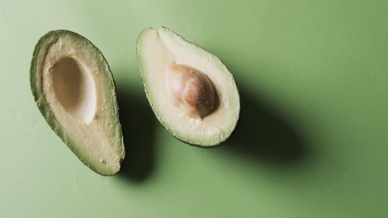 video di avocado affettato con spazio di copia su sfondo verde