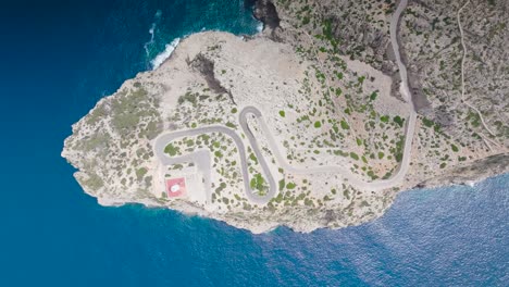 High-aerial-top-down-view-over-Formentor-Lighthouse-and-serpentine-road,-Spain