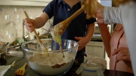 Cute-siblings-mixing-the-dough-in-the-bowl-in-kitchen-4k