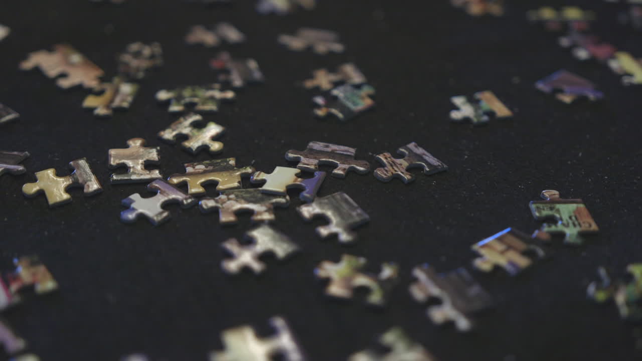 A partially solved puzzle sits amongst the other pieces on a felt mat
