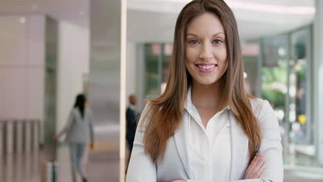 portrait of business woman at work in busy office lobby