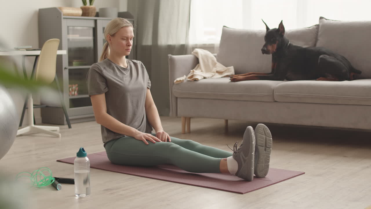 Sportswoman Stretching and Talking to Dog