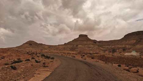 driving to ksar guermessa troglodyte village in tunisia on cloudy day