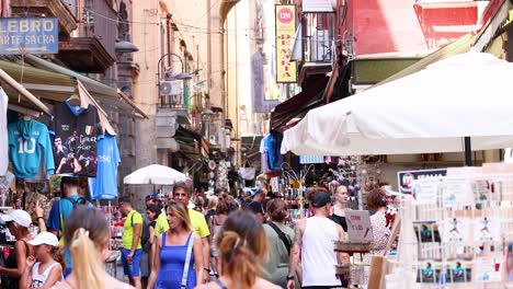 crowded market street with tourists and vendors