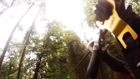 man on zip line in forest