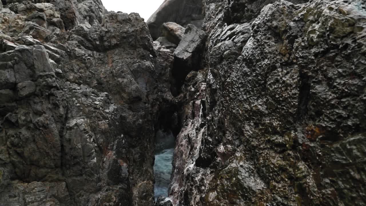 Geyser spraying out of rocks on beach near Fort Bennett, Tobago, West Indies.