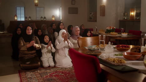 muslim women praying together during a religious gathering