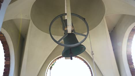 large bell ringing in slow motion in tower, close shot