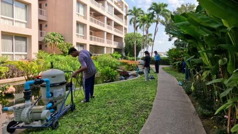 workers tending to resort landscaping with equipment.