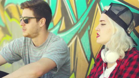 trendy young hipster couple sitting in the street