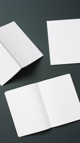 vertical video of books with white blank pages and copy space on black background