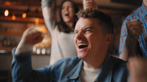 Portrait-of-a-male-fan-watching-football-in-a-bar-with-friends.-football-hockey-basketball-sports-games