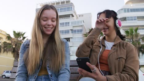 front view of a caucasian and a mixed race girl enjoying time outside
