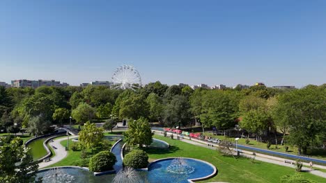 beautiful city park with ferris wheel and fountains