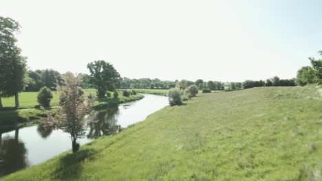 grassy hill on the banks of river slaney with the farmland in wexford, ireland