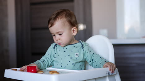 baby eating in high chair