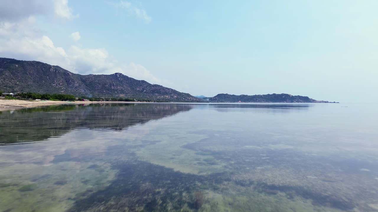 drone flies fast forward, towards distant mountains, and a clear horizon in Vietnam