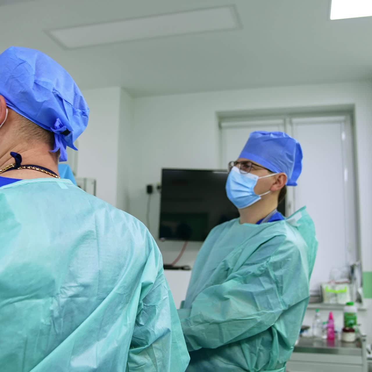 Otolaryngology surgery performed in modern clinics. Doctors work and look at the monitor. Present-day operational room at backdrop